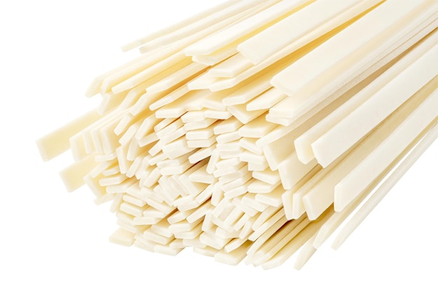 Udon raw uncooked strips are flat noodles isolated on white background with clipping path full depth of field