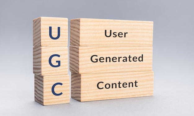 UGC User Generated Content text on wooden blocks on gray background