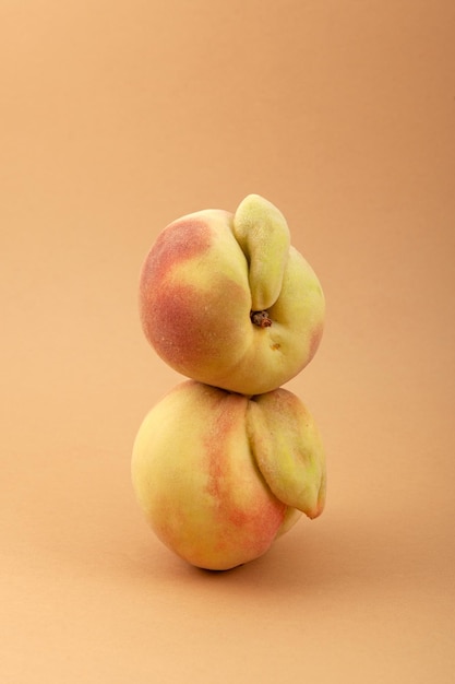 Ugly peach fruits. Deformed ripe peaches, closeup. Concept Reduce organic food waste.