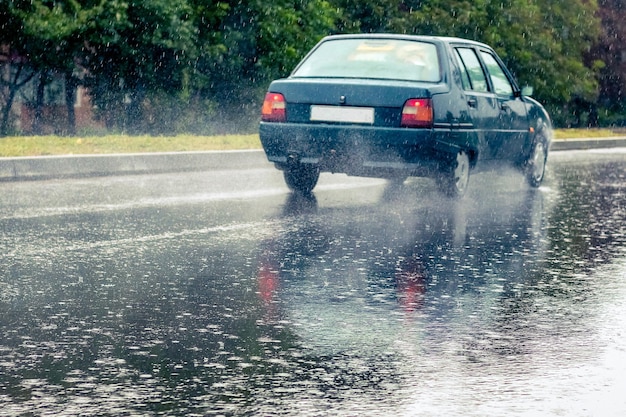 Ukraine Khmelnytsky September 2021 The car is driving on the road during heavy rain Summer rain on the track