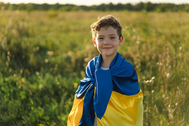 Ukraine's Independence Day Ukrainian child boy in white t shirt with yellow and blue flag of Ukraine in field Flag of Ukraine Constitution day Stand with Ukraine Save Ukraine