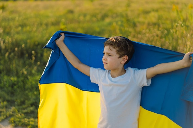 Ukraine's Independence Day Ukrainian child boy in white t shirt with yellow and blue flag of Ukraine in field Flag of Ukraine Constitution day Stand with Ukraine Save Ukraine