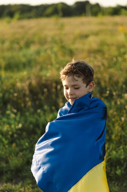 Ukraine's Independence Day Ukrainian child boy in white t shirt with yellow and blue flag of Ukraine in field Flag of Ukraine Constitution day Stand with Ukraine Save Ukraine