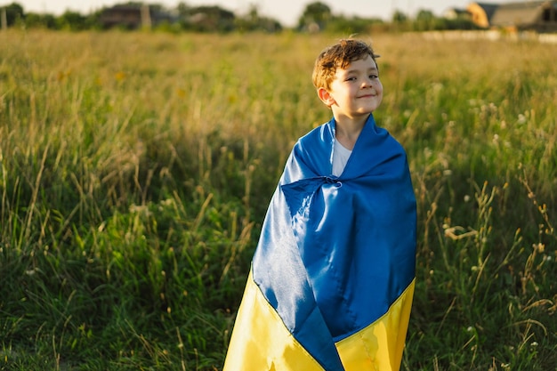 Ukraine's Independence Day Ukrainian child boy in white t shirt with yellow and blue flag of Ukraine in field Flag of Ukraine Constitution day Stand with Ukraine Save Ukraine