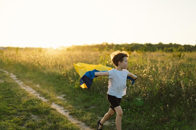 Ukraine's Independence Day Ukrainian child boy in white t shirt with yellow and blue flag of Ukraine in field Flag of Ukraine Constitution day Stand with Ukraine Save Ukraine