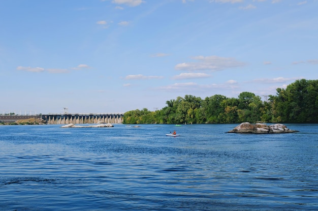 Ukraine, Zaporozhye. View of Dnieper river, rocks, green hills. Khortytsya Island. Dam Dneproges