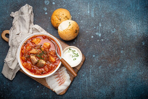 Ukrainian borscht red beetroot soup with meat in white bowl