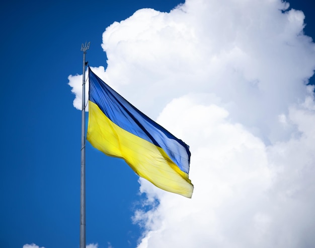 Ukrainian flag on the background of the sky with a cloud