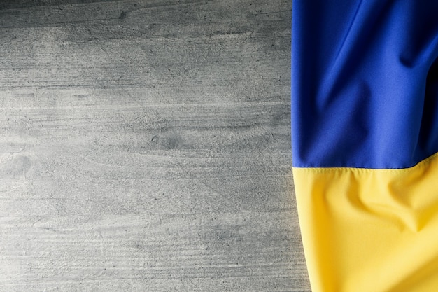 Ukrainian flag on gray wooden background space for text