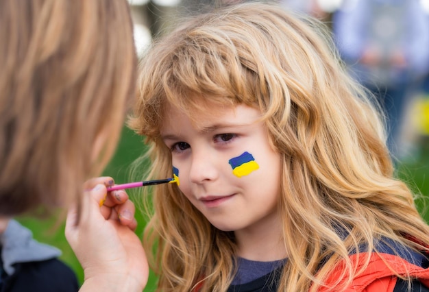 Ukrainian flag on kids cheek no war with ukraine putin attack ukrainian people