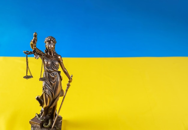 Ukrainian flag with the statue of Lady Justice holding scales