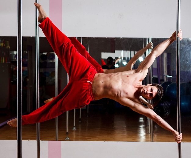 Ukrainian gymnast doing gymnastics with aerial hoop or aerial hoop in the fitness room