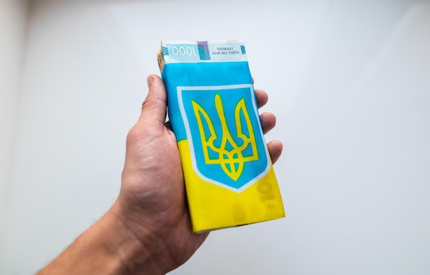 The Ukrainian hryvnia is wrapped in the Flag of Ukraine