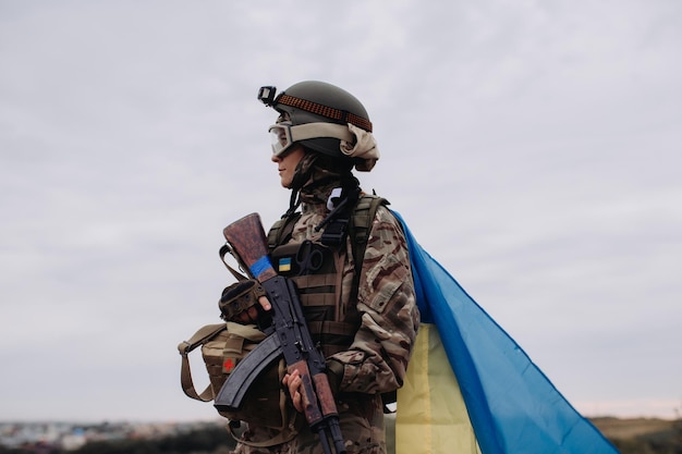 Ukrainian woman defender in the warxAPortrait of a military woman with the flag of Ukraine