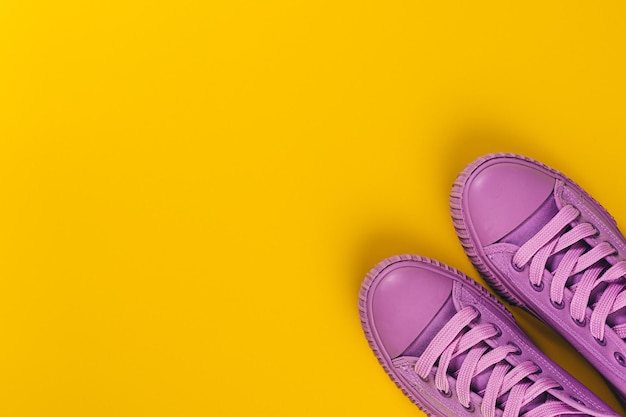 Ultra Violet sneakers on yellow background. Concept of healthy lifestile and food, everyday training and force of will.