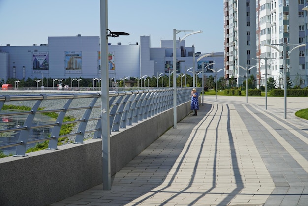 Ulyanovsk Russia July 25 2022 A woman watches wild ducks in the water on the Embankment of the Sviyaga River