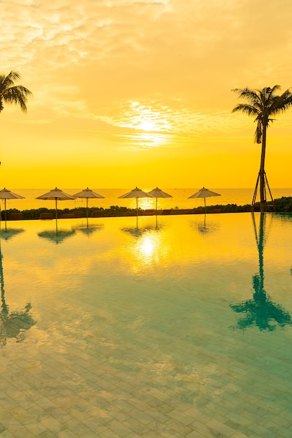 Umbrella with bed pool around swimming pool with ocean sea background