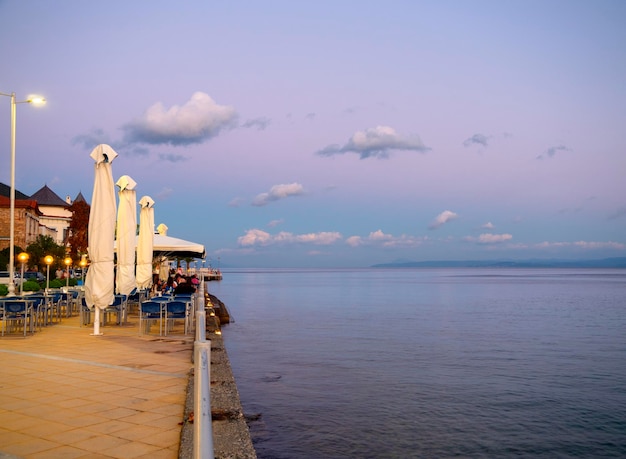 Umbrellas in a Greek tavern without visitors at sunset in Greece