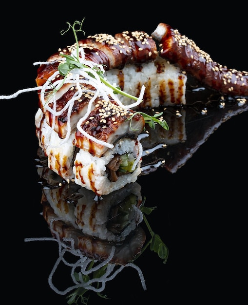 Unagi Dragon roll with eel on glossy black background