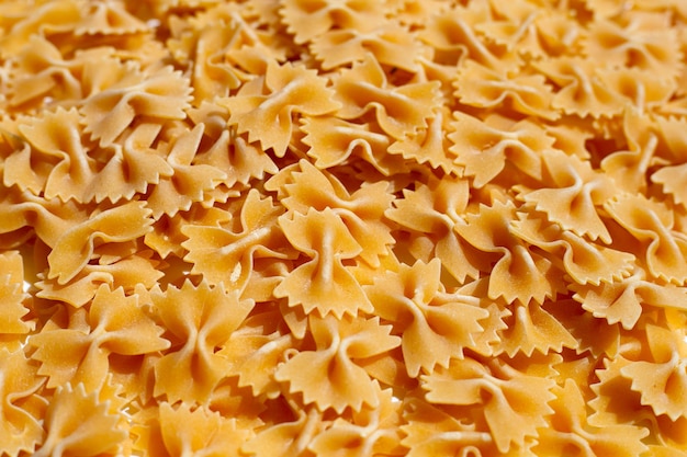 Uncooked bow tie pasta background