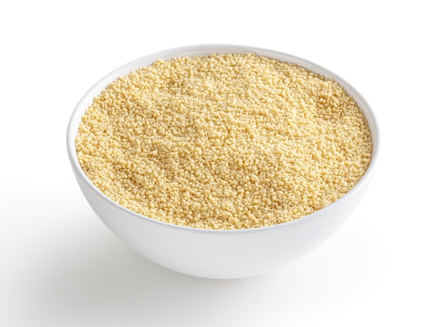 Uncooked cous cous in white bowl isolated on white background with clipping path