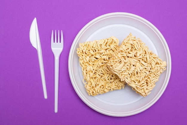 Uncooked instant noodles on white plate