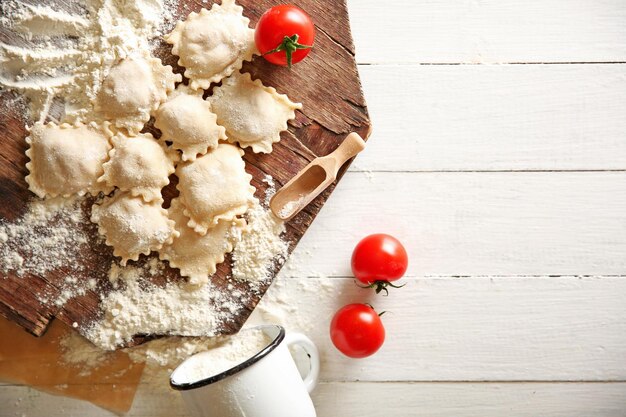 Uncooked ravioli on cutting board