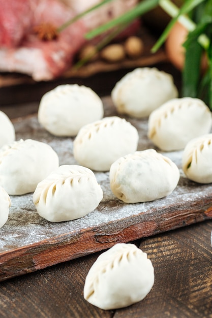 Uncooked raw Manti. Central Asian traditional dumplings meat dish with meat, onion jusai. Unprepared