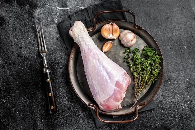 Uncooked turkey legs Drumsticks raw Poultry meat Black background Top view