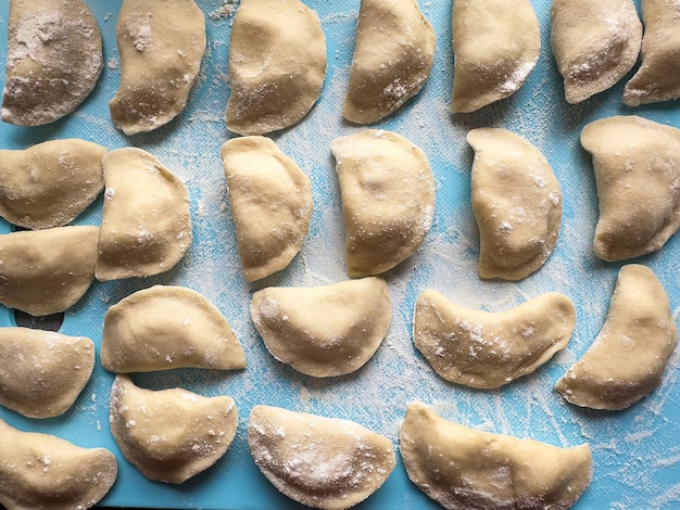 Uncooked ukraine vareniki dumplings tortellini home hand made with potatoes and onion