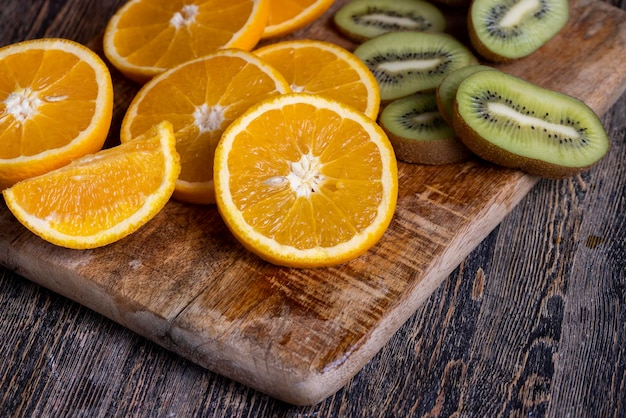 Uncut orange on a wooden chopping board