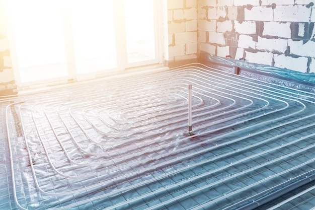 Underfloor heating pipes installation on construction site