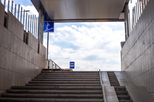 An underground passage with steps leading upwards Infrastructure of the city with heavy traffic