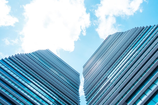 Underside panoramic and perspective view to steel blue glass high rise building skyscrapers business concept of successful industrial architecture