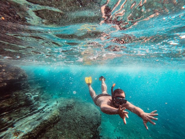 Underwater photo of men diver snorkeling in the sea