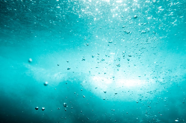 Underwater View of Bubbles In Deep Blue Ocean Close Up Water Background