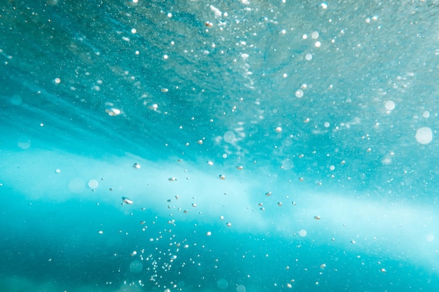 Underwater View of Bubbles In Deep Blue Sea Close Up Water Background