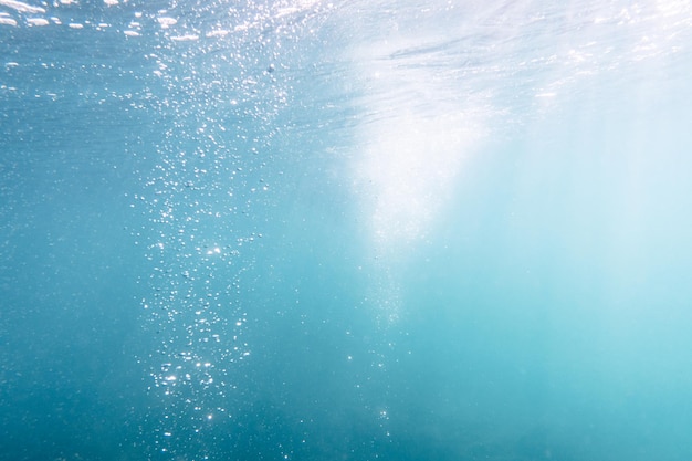 Underwater View of Bubbles In Deep Blue Sea Close Up Water Background