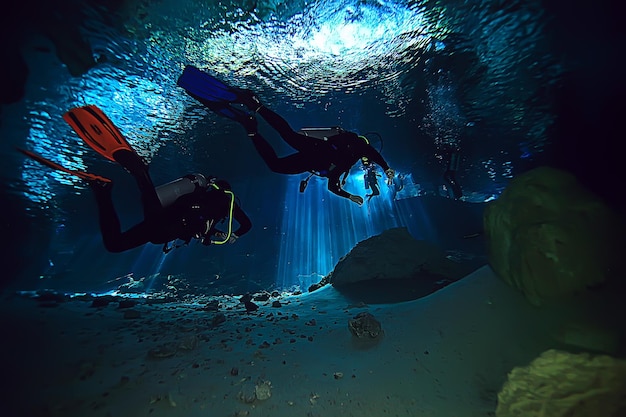 underwater world cave of yucatan cenote, dark landscape of stalactites underground, diver