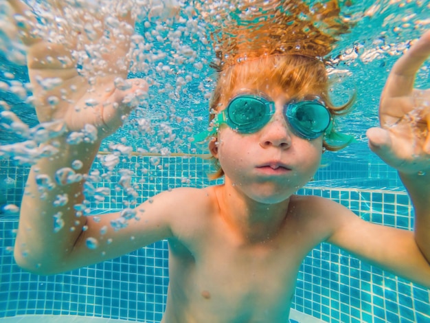 Underwater Young Boy Fun in the Swimming Pool with Goggles Summer Vacation Fun