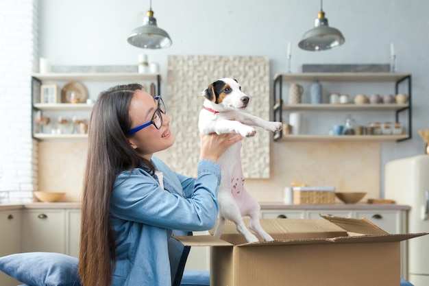 An unexpected gift happy and amazed young asian woman received a gift parcel of a small dog he is