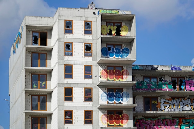 Unfinished abandoned residential building covered with graffiti