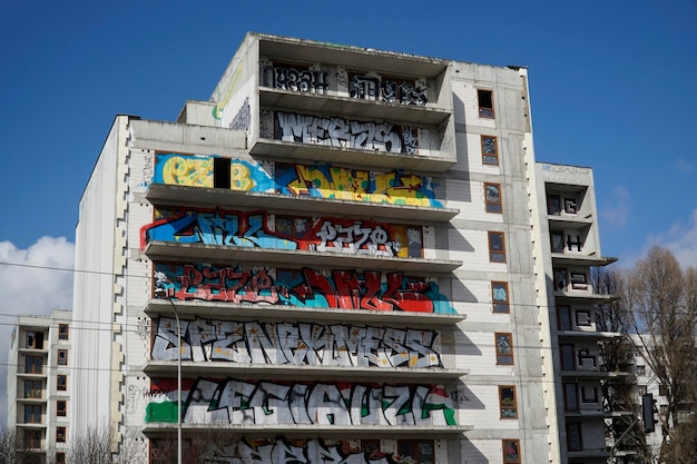 Unfinished abandoned residential building covered with graffiti