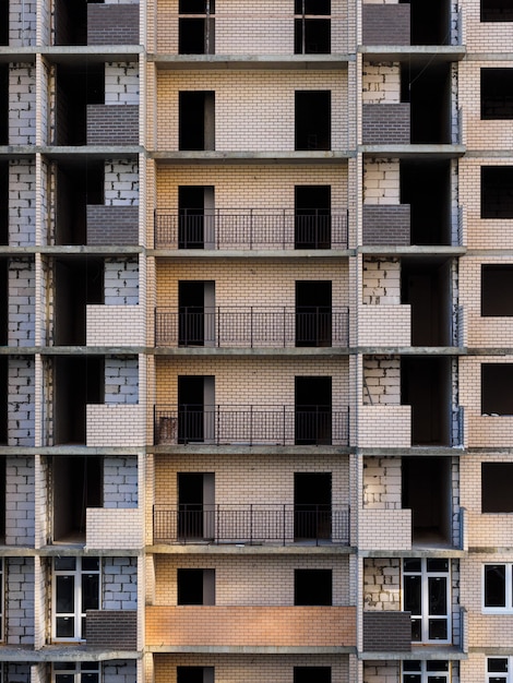 Unfinished multi-storey building. Brick building under construction