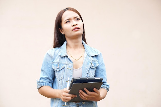 Unhappy Asian women using portable computers because the operating results have decreased profits