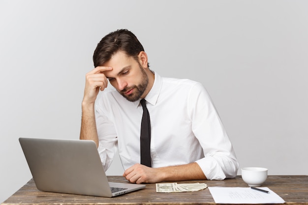 unhappy male working in the office, looking at the camera, front view, isolated on white.