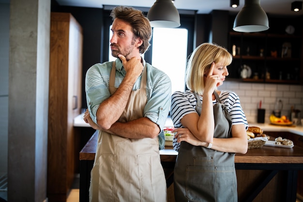 Unhappy married couple having argument and fight in kitchen that leads to divorce