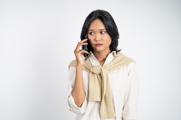 Unhappy woman making a call using a smart phone