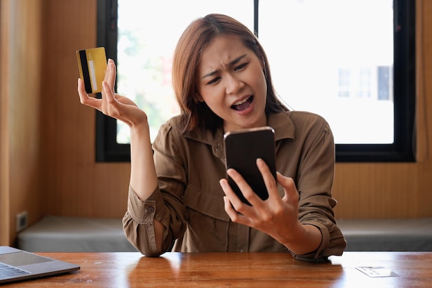 Unhappy young asian female buyer have problems buying online on internet on smartphone with credit card Angry frustrated woman confused with account money loss shopping on web on cellphone