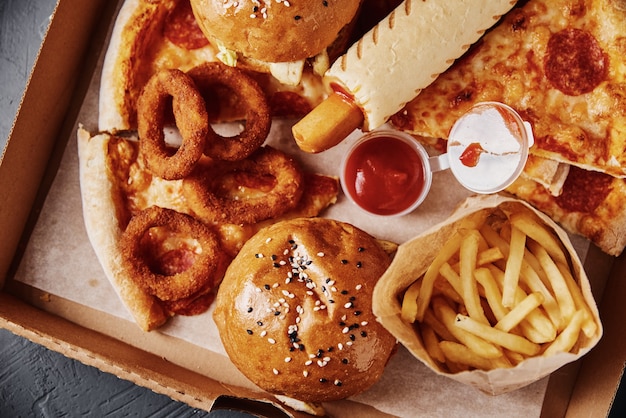 Unhealthy and junk food. Different types of fast food on the table, close up